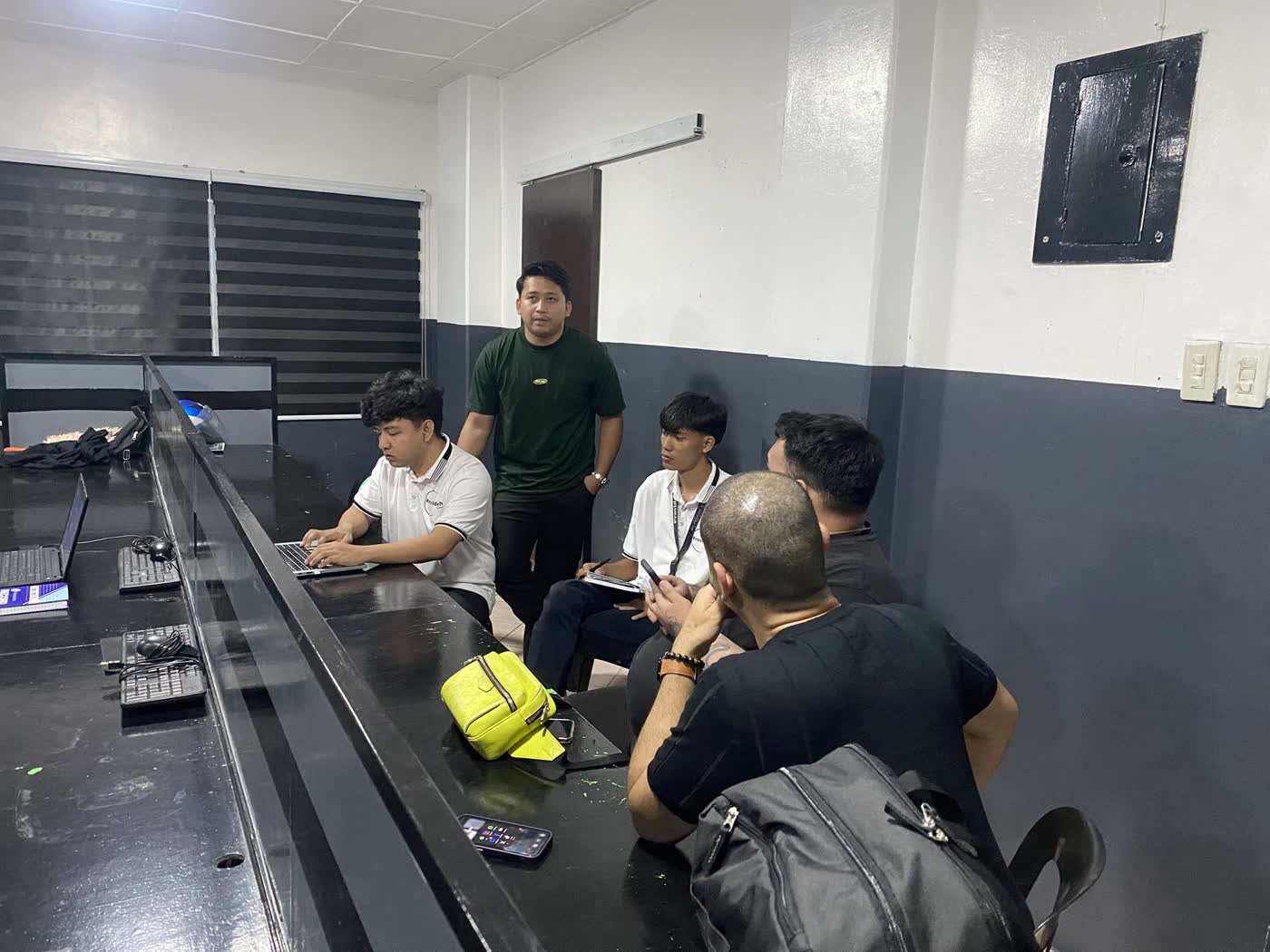 Coach guiding clients through a build in the training room